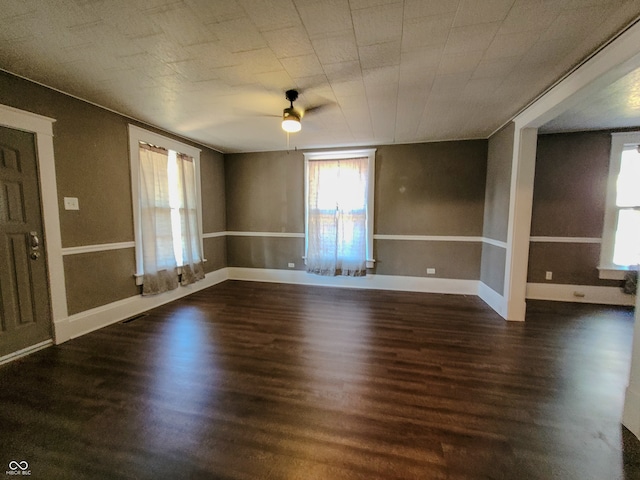 spare room with dark hardwood / wood-style floors and ceiling fan