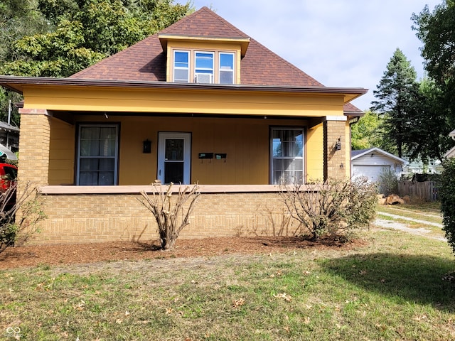 bungalow-style house featuring a porch and a front yard