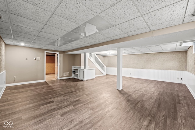 basement with hardwood / wood-style floors and a drop ceiling