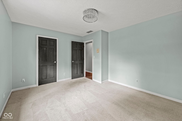 unfurnished bedroom with carpet and a textured ceiling