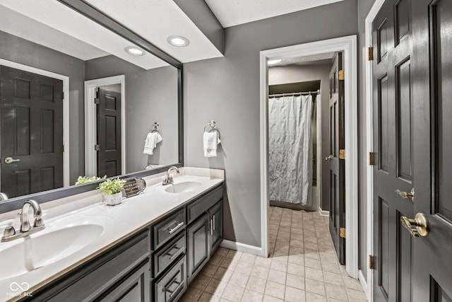 bathroom with vanity, curtained shower, and tile patterned flooring