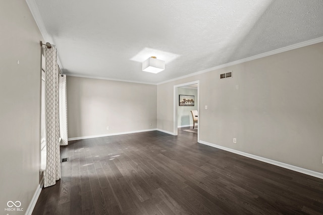 spare room with a textured ceiling, dark hardwood / wood-style flooring, and ornamental molding