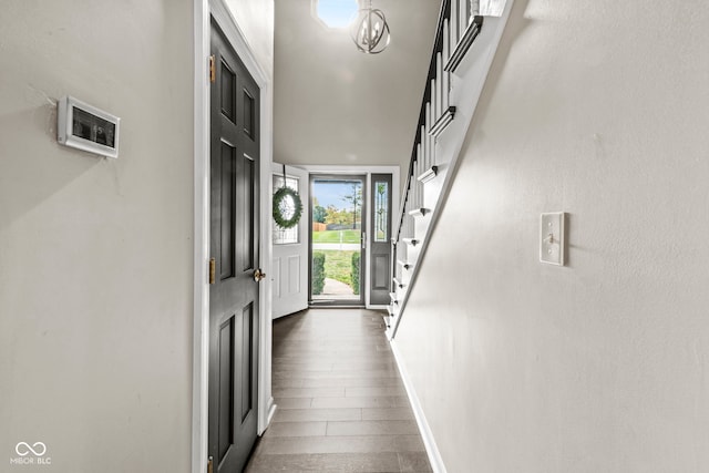 doorway to outside featuring dark wood-type flooring and a high ceiling