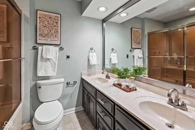 full bathroom featuring vanity, enclosed tub / shower combo, toilet, and tile patterned flooring