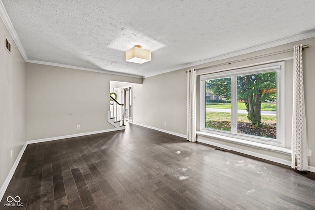 empty room featuring ornamental molding, a textured ceiling, and dark wood-type flooring