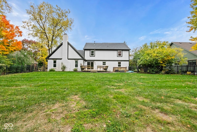 rear view of house with a yard