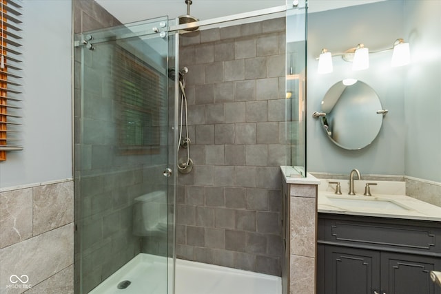 bathroom featuring vanity and a shower with shower door