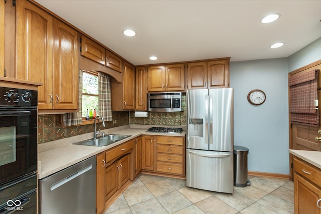 kitchen with sink, stainless steel appliances, light tile patterned floors, and tasteful backsplash