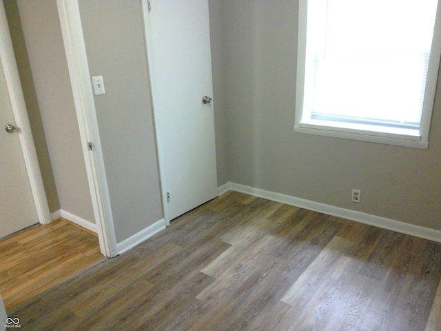 unfurnished bedroom featuring hardwood / wood-style flooring and a closet