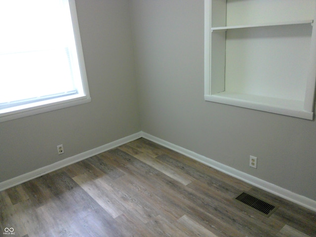 spare room featuring dark hardwood / wood-style flooring