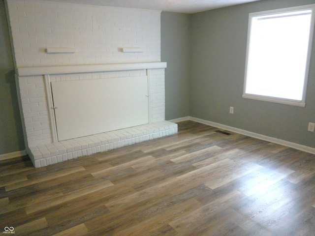 unfurnished living room with dark wood-type flooring