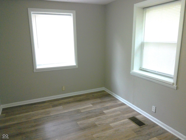 spare room with hardwood / wood-style floors