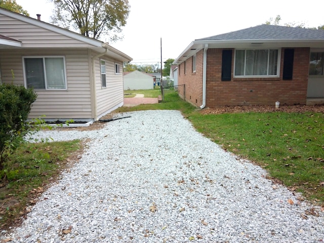 view of side of home featuring a yard