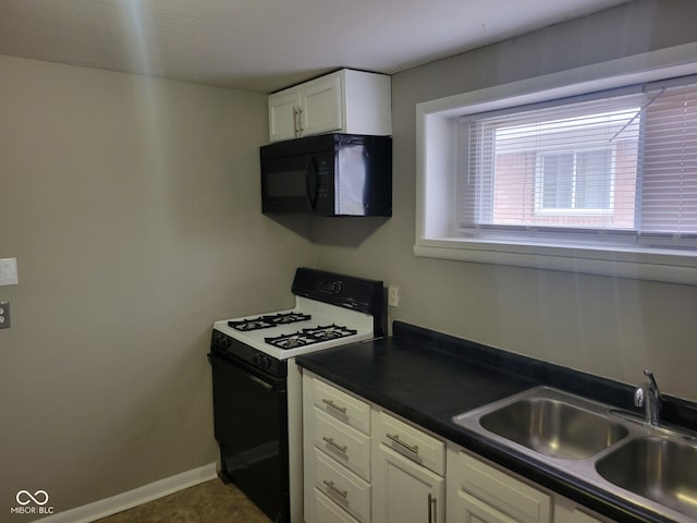 kitchen featuring white cabinetry, sink, and gas range oven