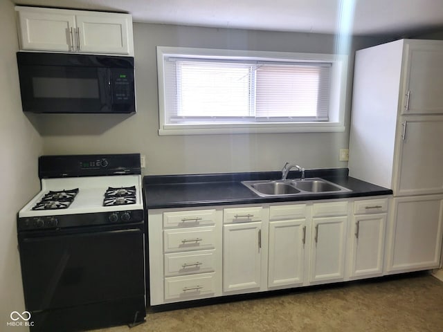 kitchen with gas range, white cabinetry, and sink