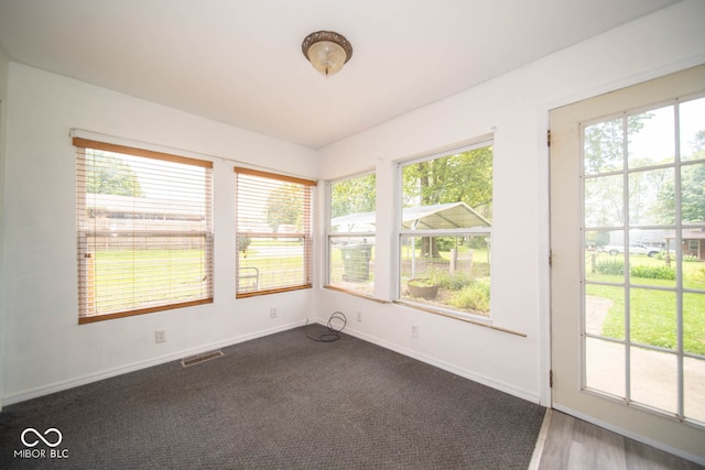 unfurnished sunroom with a healthy amount of sunlight