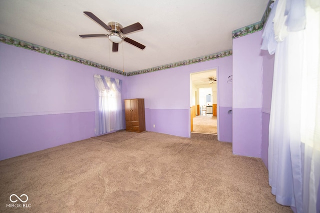 unfurnished bedroom featuring light carpet and ceiling fan