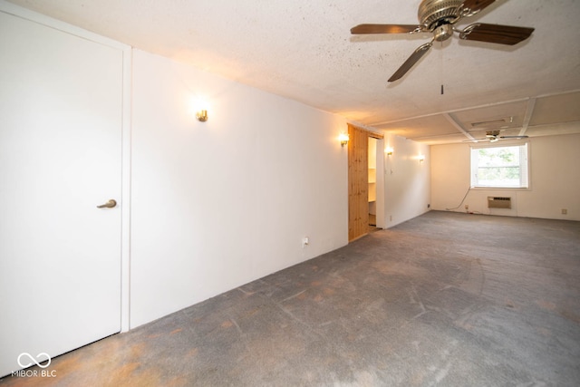 carpeted empty room with a wall unit AC, a textured ceiling, and ceiling fan