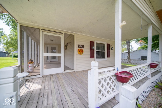 wooden terrace featuring covered porch