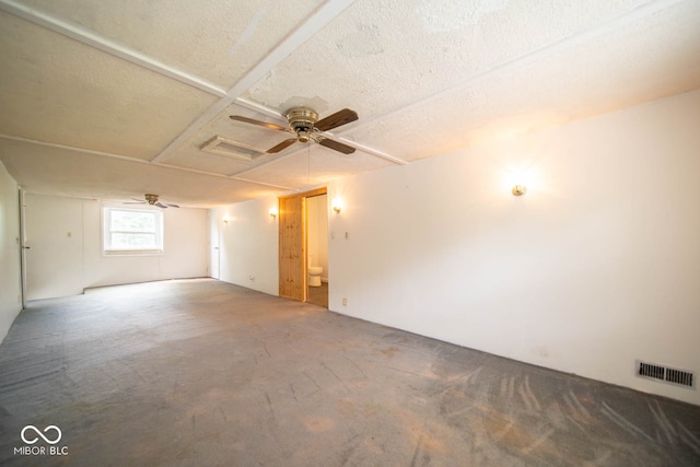 carpeted spare room with a textured ceiling and ceiling fan