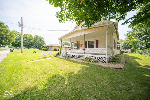 view of front of house with covered porch and a front lawn