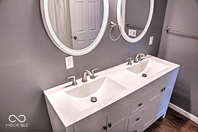 bathroom with vanity and hardwood / wood-style floors