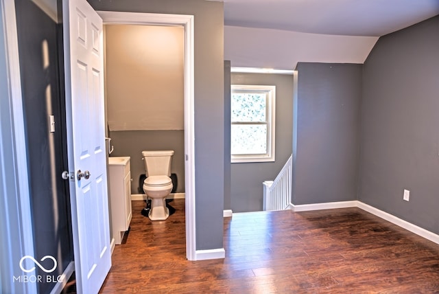 bathroom featuring toilet, lofted ceiling, and wood-type flooring