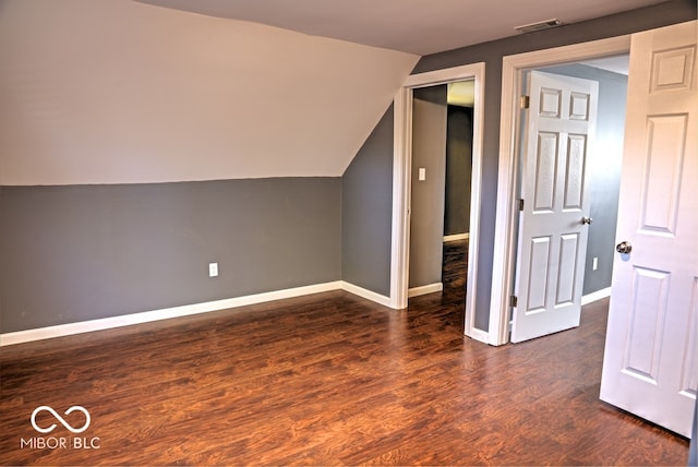 additional living space with lofted ceiling and dark hardwood / wood-style flooring