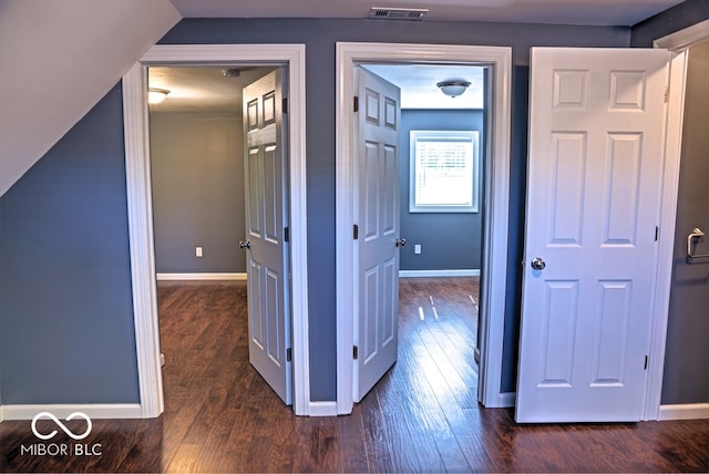 corridor featuring dark hardwood / wood-style flooring