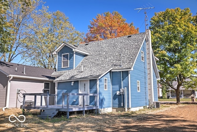 view of front of property featuring cooling unit and a wooden deck