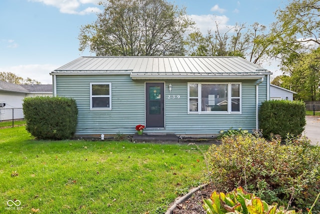 bungalow-style house with a front yard