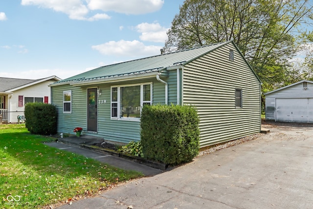 view of home's exterior featuring a lawn, an outbuilding, and a garage