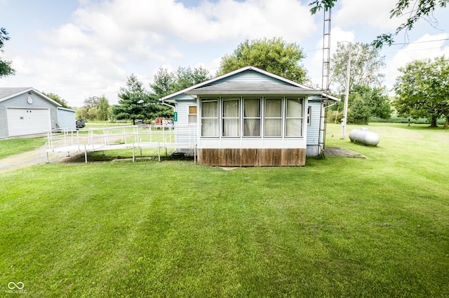 exterior space with an outbuilding, a garage, and a lawn