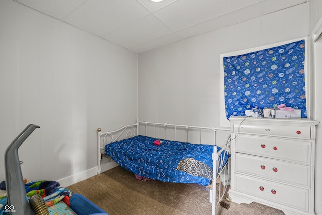 bedroom with a paneled ceiling and carpet flooring