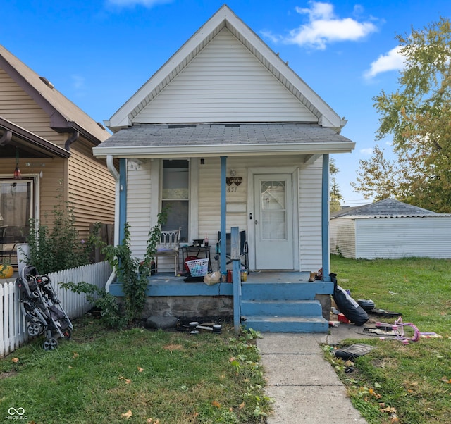 bungalow-style house with covered porch and a front lawn