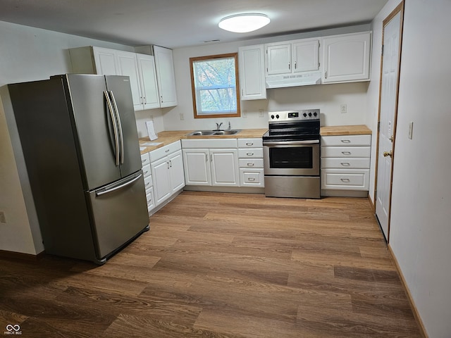 kitchen with ventilation hood, sink, light hardwood / wood-style flooring, white cabinetry, and stainless steel appliances