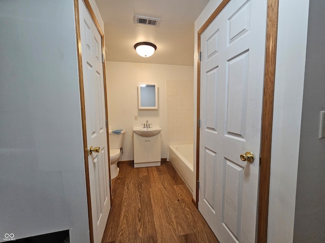 corridor featuring sink and dark hardwood / wood-style floors