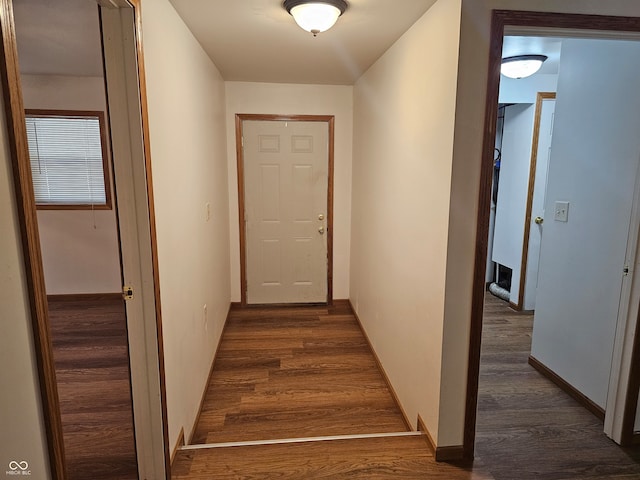 hallway with dark wood-type flooring