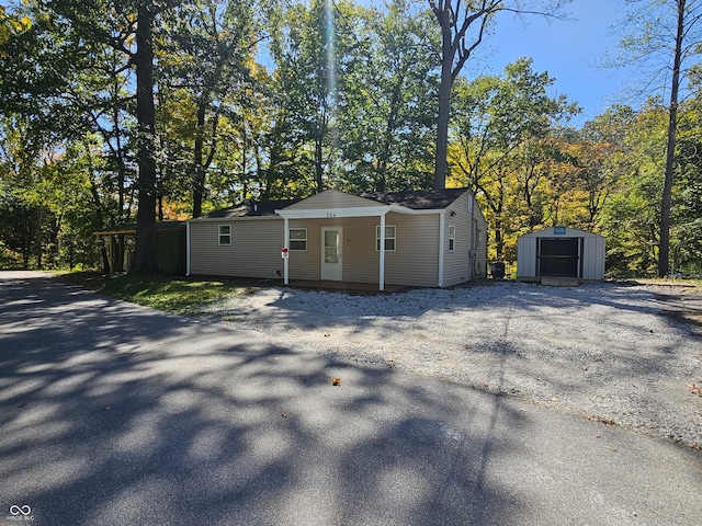 exterior space featuring a porch and a shed