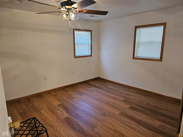 spare room featuring ceiling fan and dark hardwood / wood-style flooring