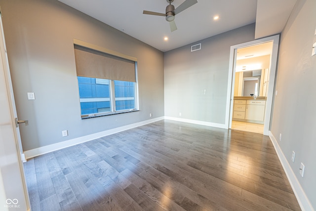 spare room with ceiling fan and hardwood / wood-style flooring