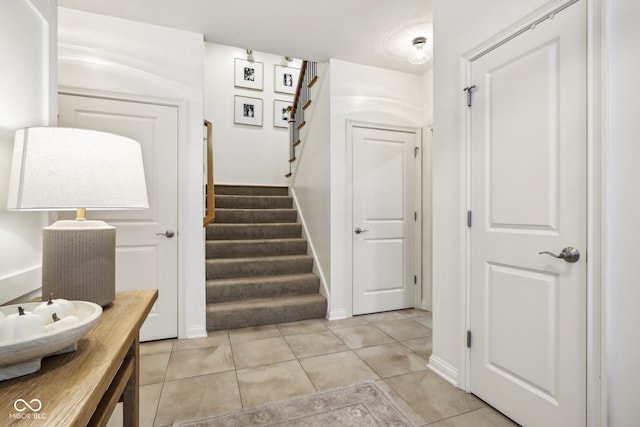 stairway with tile patterned floors