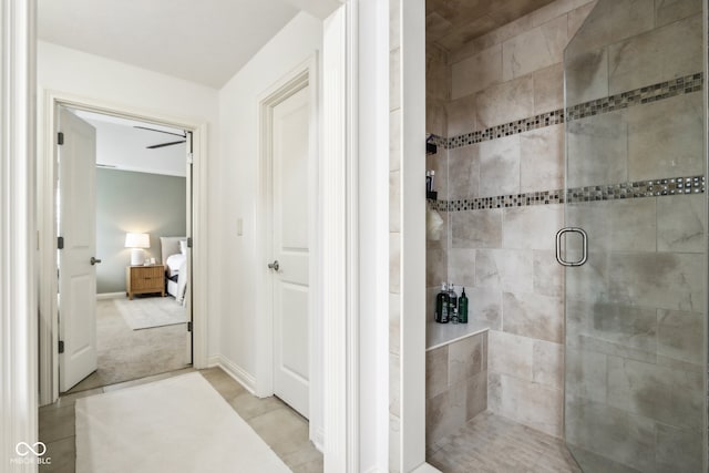 bathroom featuring tile patterned floors and a shower with shower door