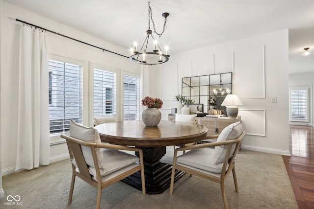 dining area with a chandelier, hardwood / wood-style flooring, and a healthy amount of sunlight