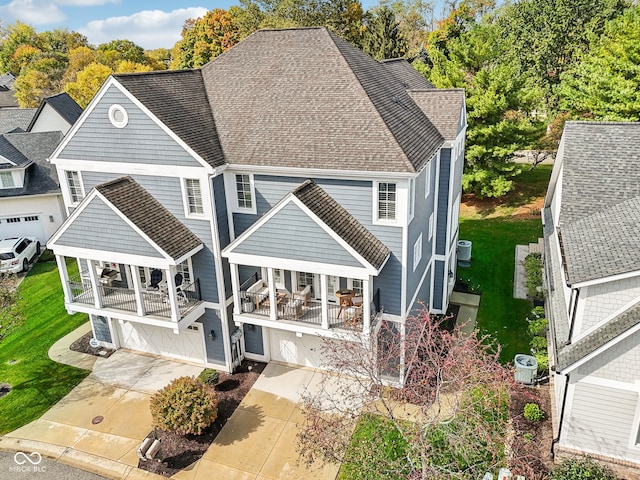 back of property featuring a lawn and a garage