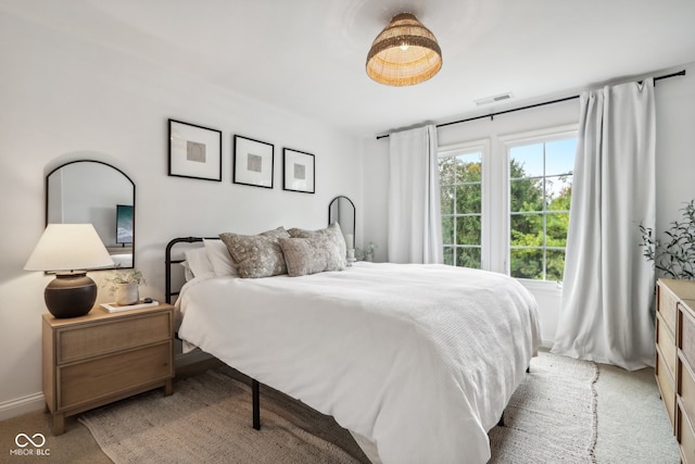 bedroom featuring light colored carpet