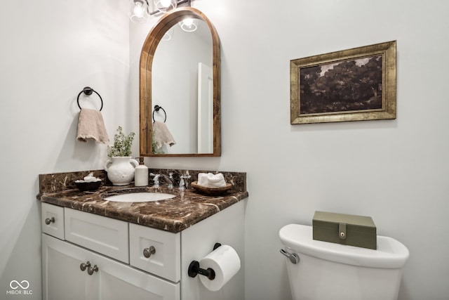 bathroom featuring toilet and vanity