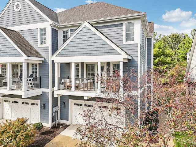 view of front of property featuring a balcony and a garage