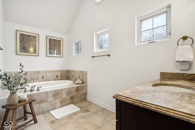 bathroom featuring vanity, tiled tub, plenty of natural light, and vaulted ceiling