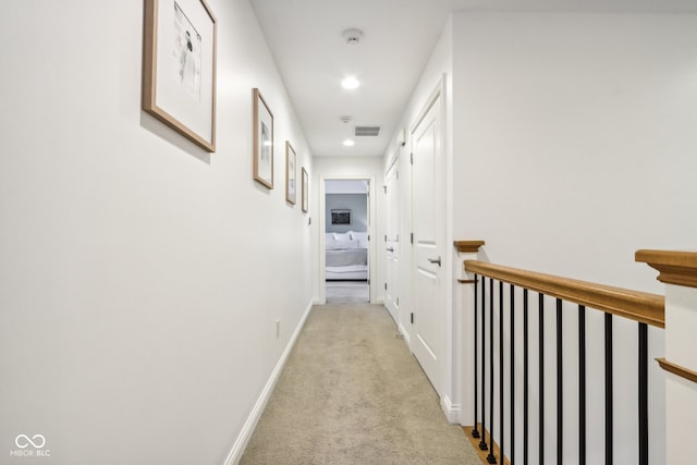 corridor featuring light carpet